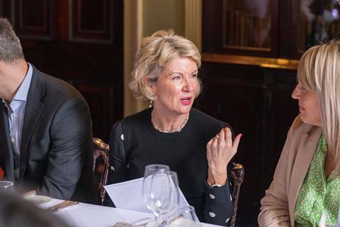 Photograph of Carpenters Group director Donna Scully in conversation with a fellow attendee to her left at the Fraud Charter roundtable, hosted by Insurance Times.